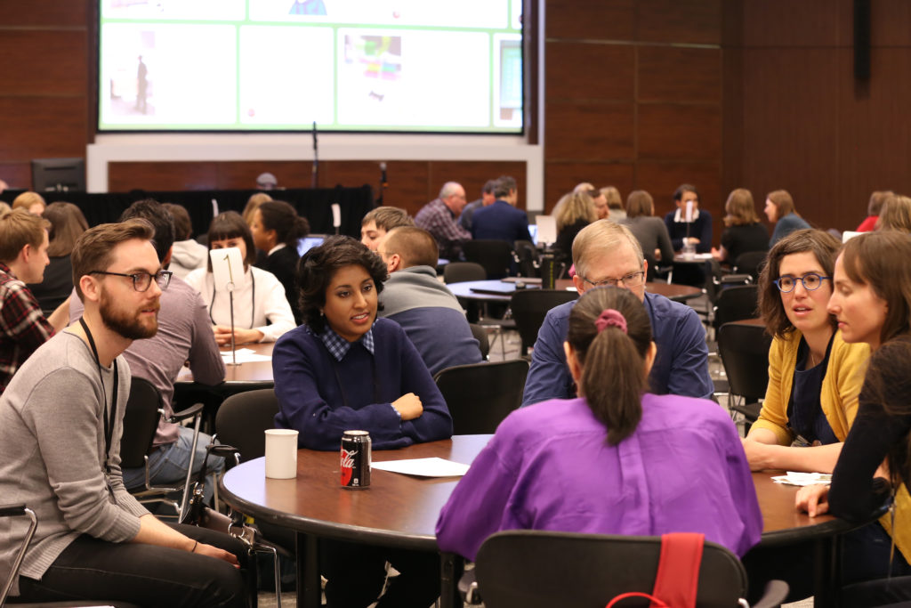 Attendees from ebookcraft 2019 sitting and talking at a roundtable discussion.